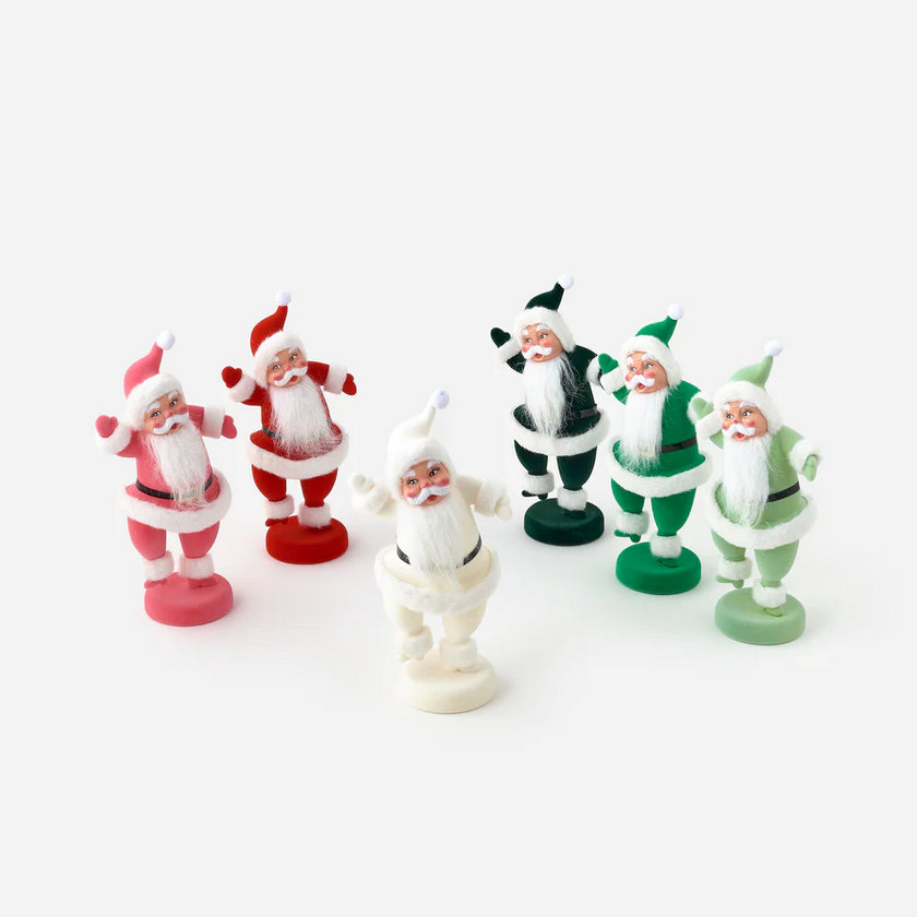 Set of six Santa Claus figurines in different poses and colors on a white background