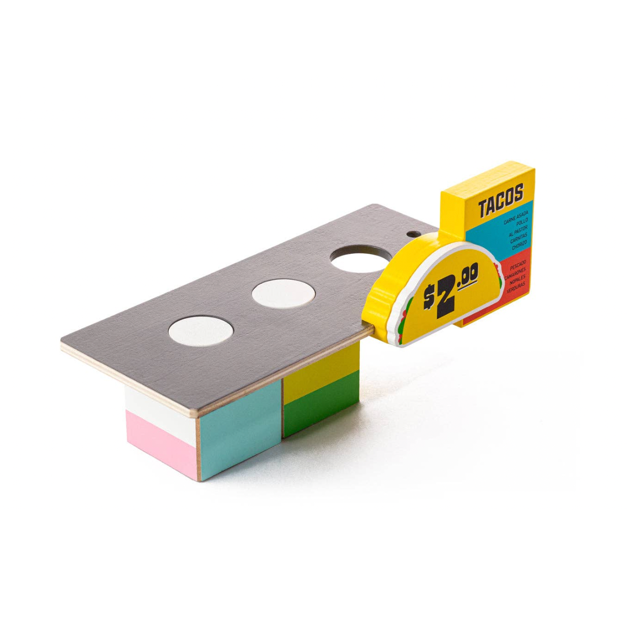 Colorful toy resembling a taco stand on a white background