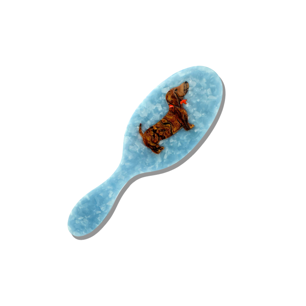 Blue hairbrush with a butterfly design on a white background