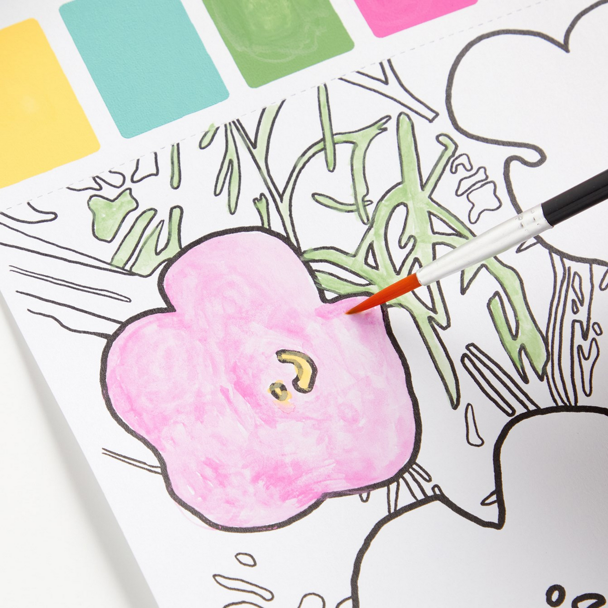 Coloring book page with a pink flower and green leaves, being colored with a red pencil.