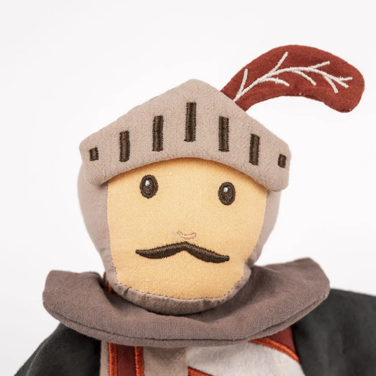 Toy figure of a knight with a helmet and armor on a white background