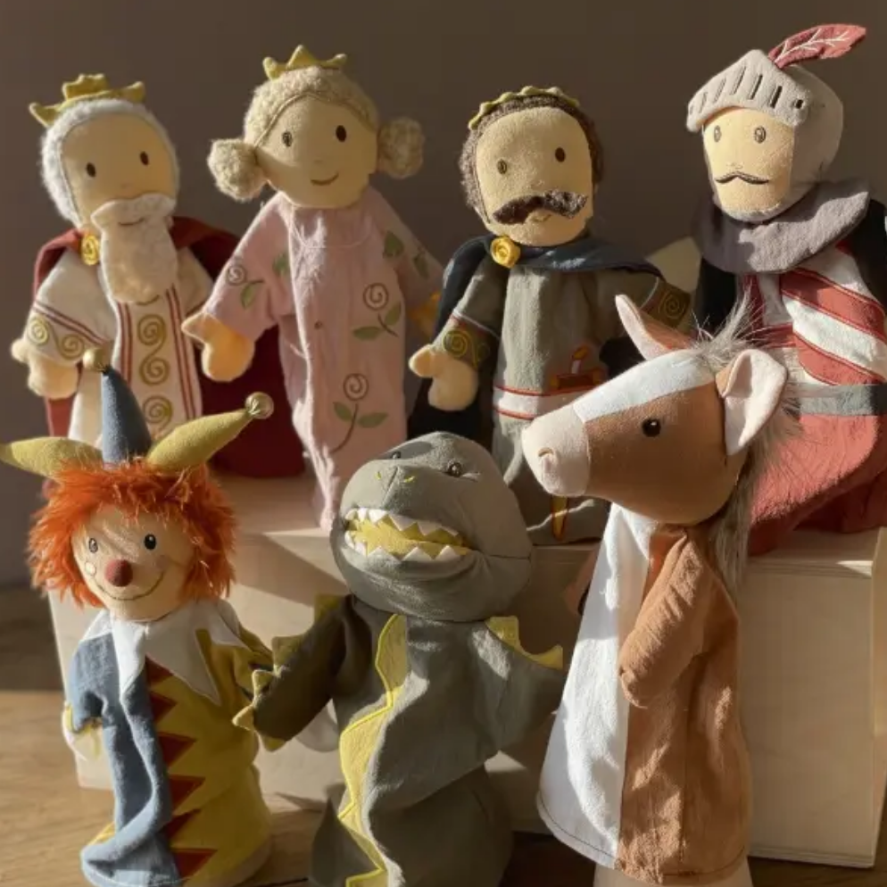 Set of colorful puppet characters on a wooden surface