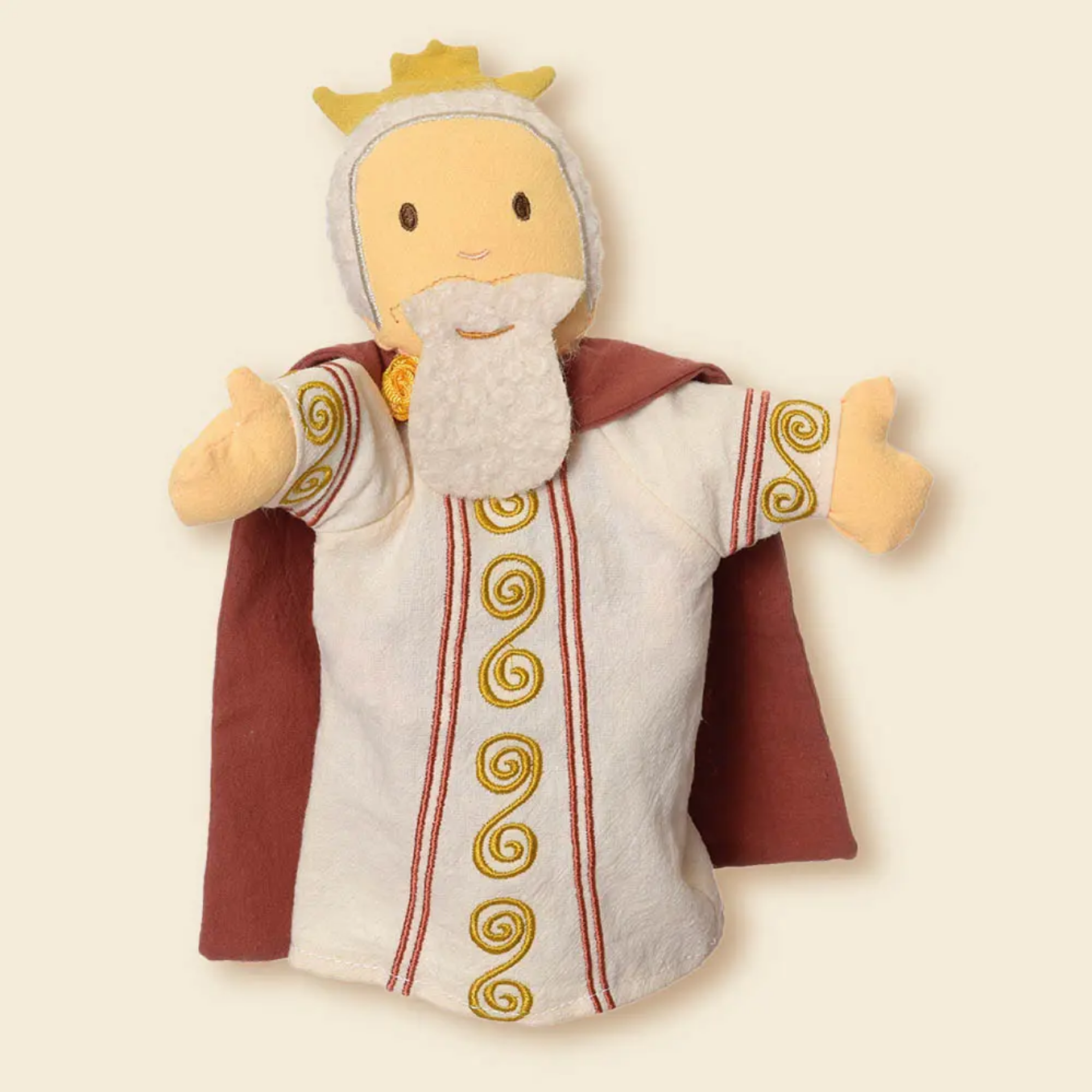 Plush puppet of a king with a crown, robe, and beard on a beige background