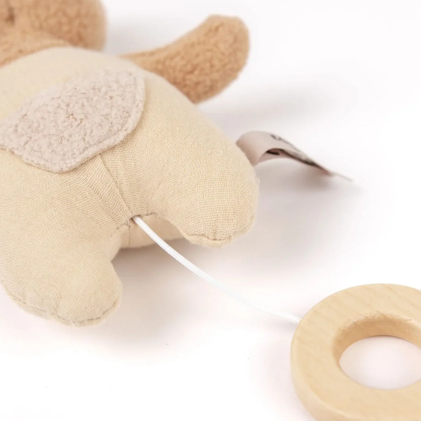 Plush toy with a wooden ring on a white background