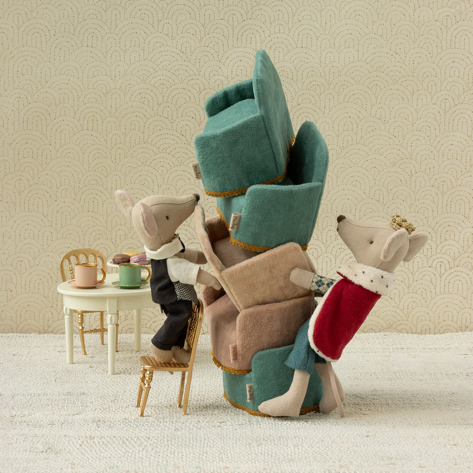Stack of plush chairs with animal figures in a room setting