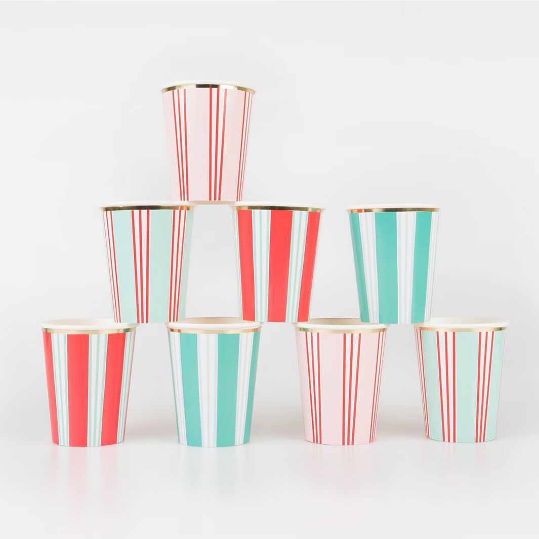 Stack of red and green striped paper cups on a white background