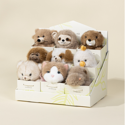Set of small plush toys in a box on a beige background