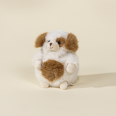 Stuffed animal resembling a dog with brown and white fur on a beige background