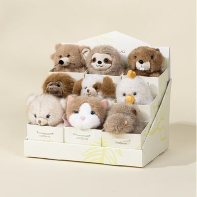 Set of small plush toys in a box on a beige background