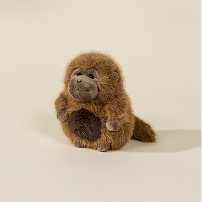 Plush monkey toy on a beige background