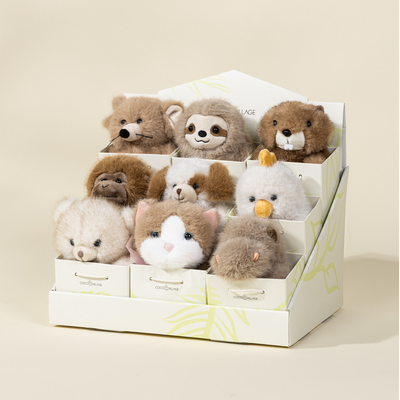 Set of small plush toys in a box on a beige background