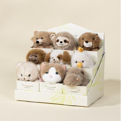 Set of small plush toys in a box on a beige background
