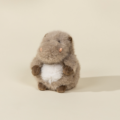 Plush toy resembling a HIPPO on a beige background