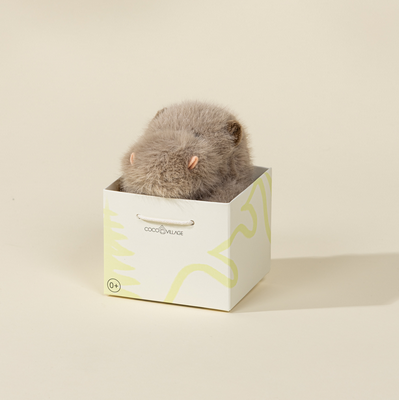 Small gray hippo inside a white box with green abstract designs on a beige background