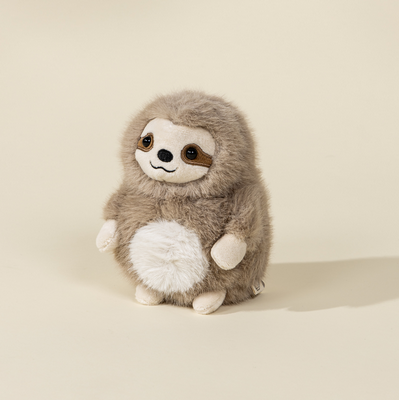 Plush toy sloth on a beige background