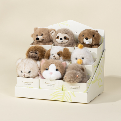 Set of small plush toys in a box on a beige background