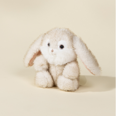 Plush bunny toy on a beige background