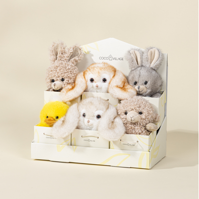 Set of small plush toys in a box on a beige background