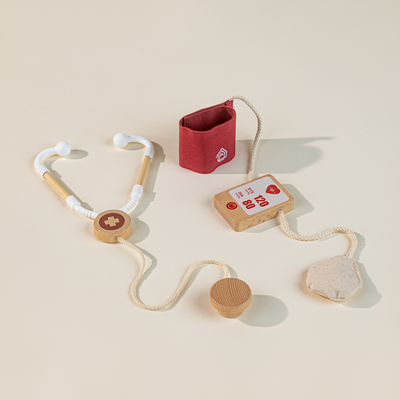 Wooden toy stethoscope and red pouch on a beige background