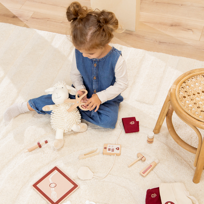 Child playing with toys on a light-colored floor