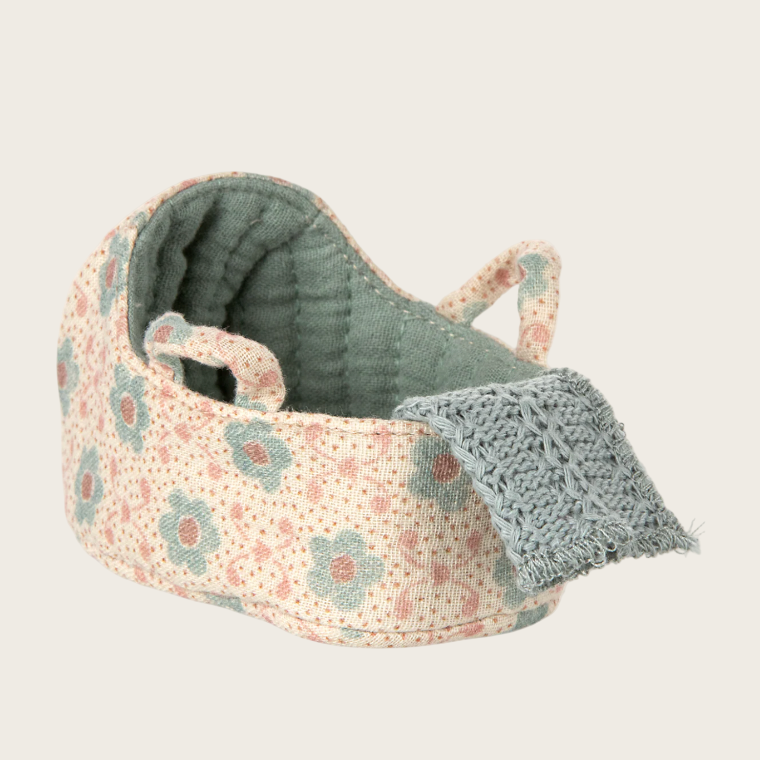 Floral-patterned baby bassinet with gray cover 