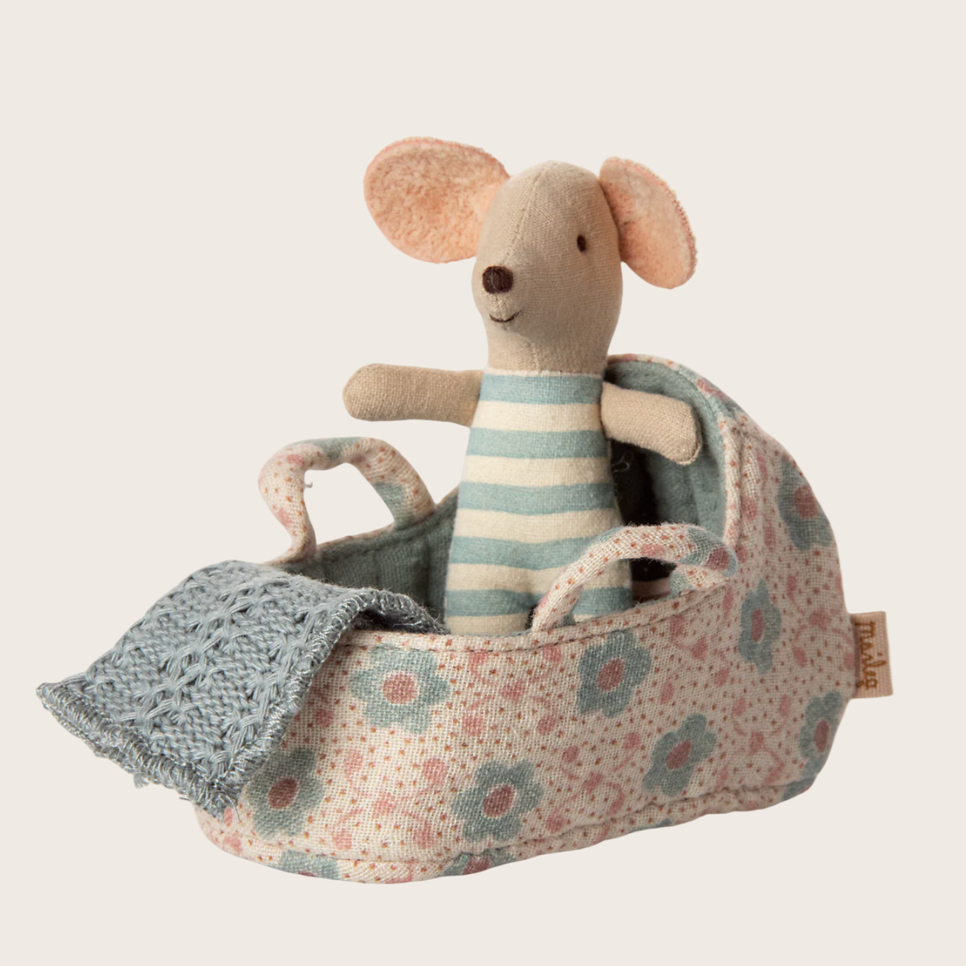 Stuffed toy mouse in a floral baby carriage 