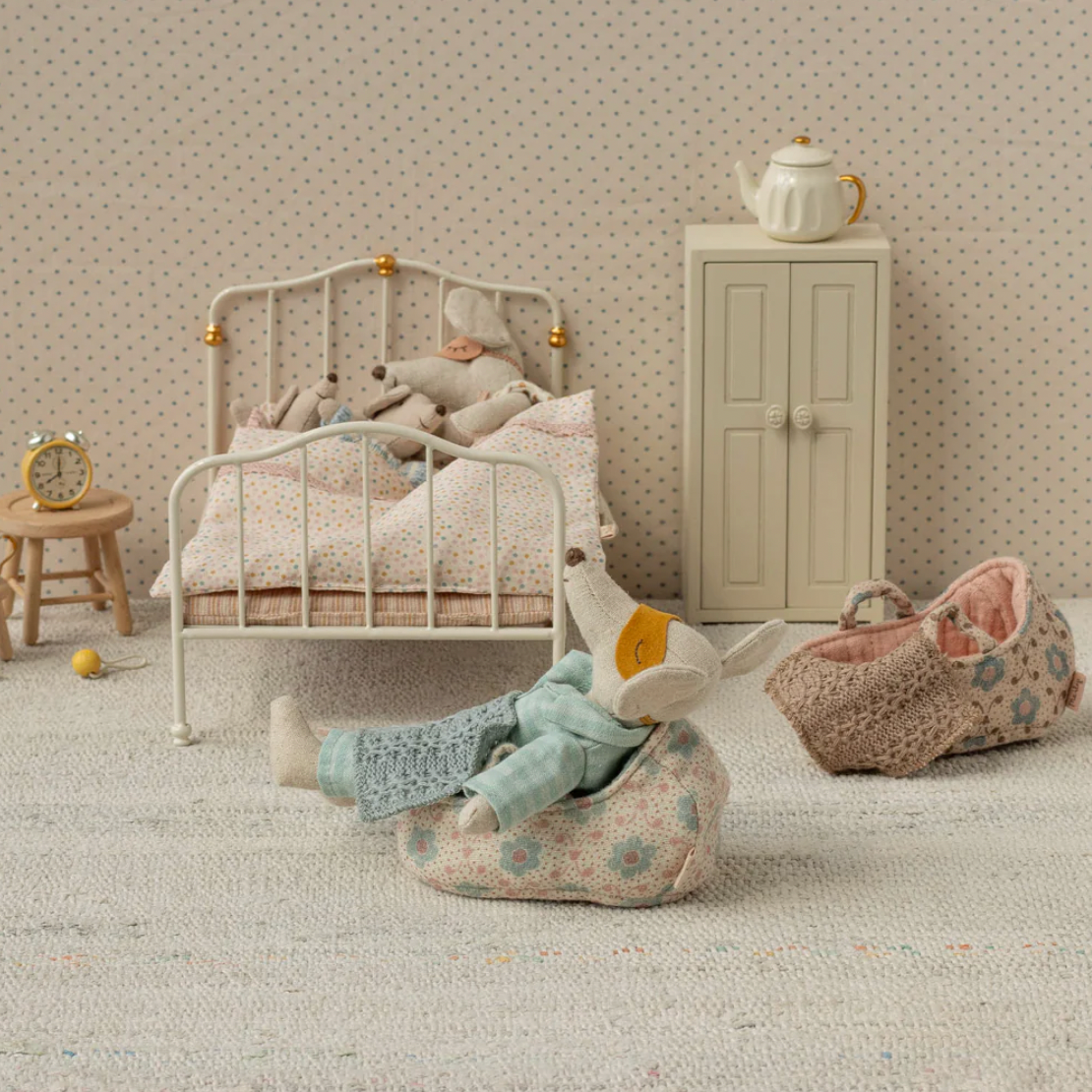 Children's room with a bed, toys, and furniture 