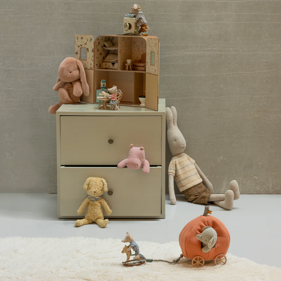 Children's furniture set with toy chest and plush toys on a neutral background