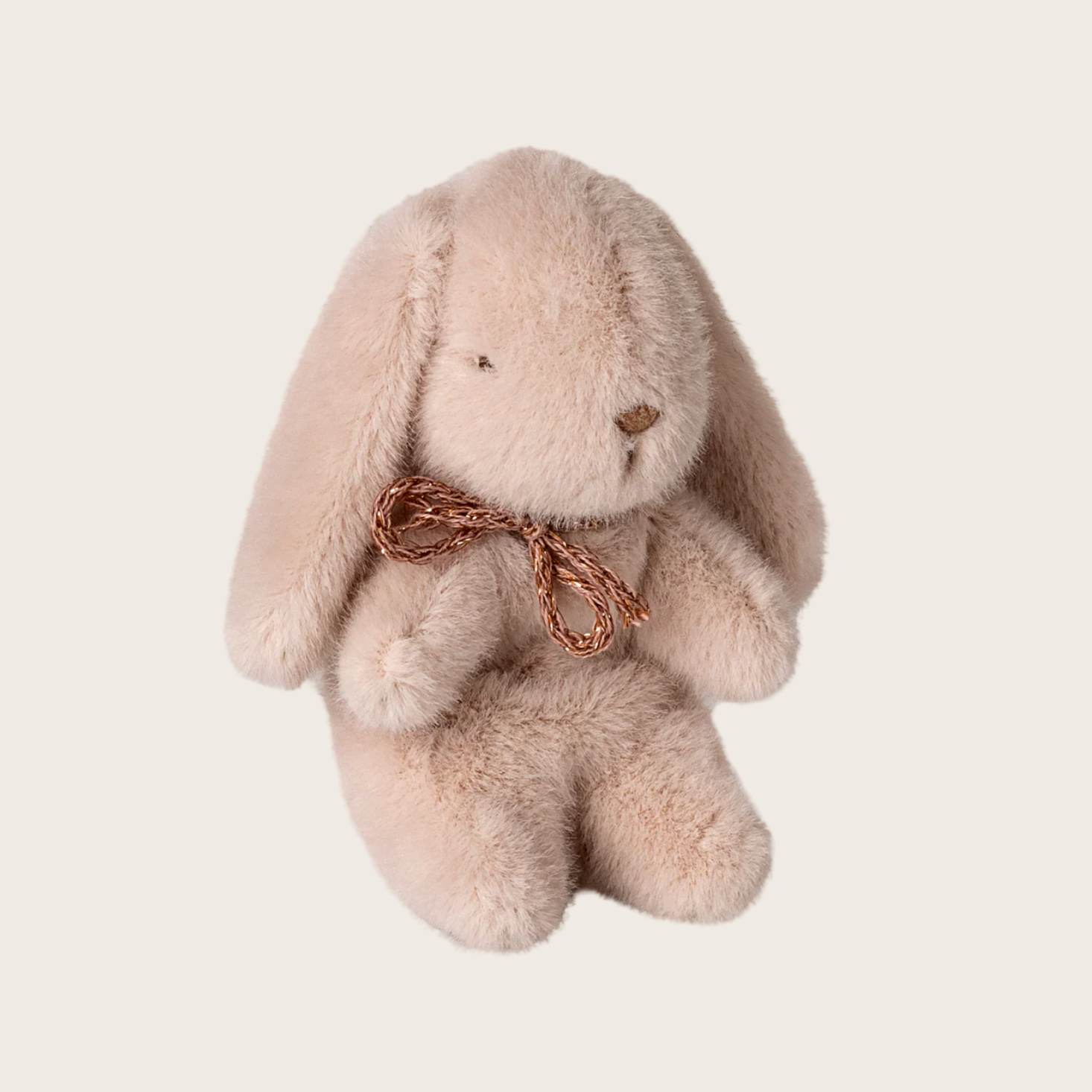 Plush bunny toy with a bow on a white background