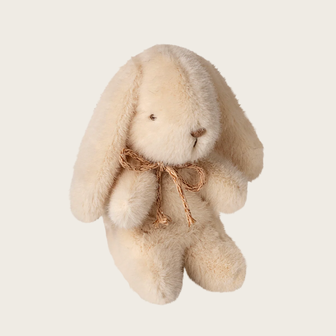 Beige plush bunny with a bow on a white background
