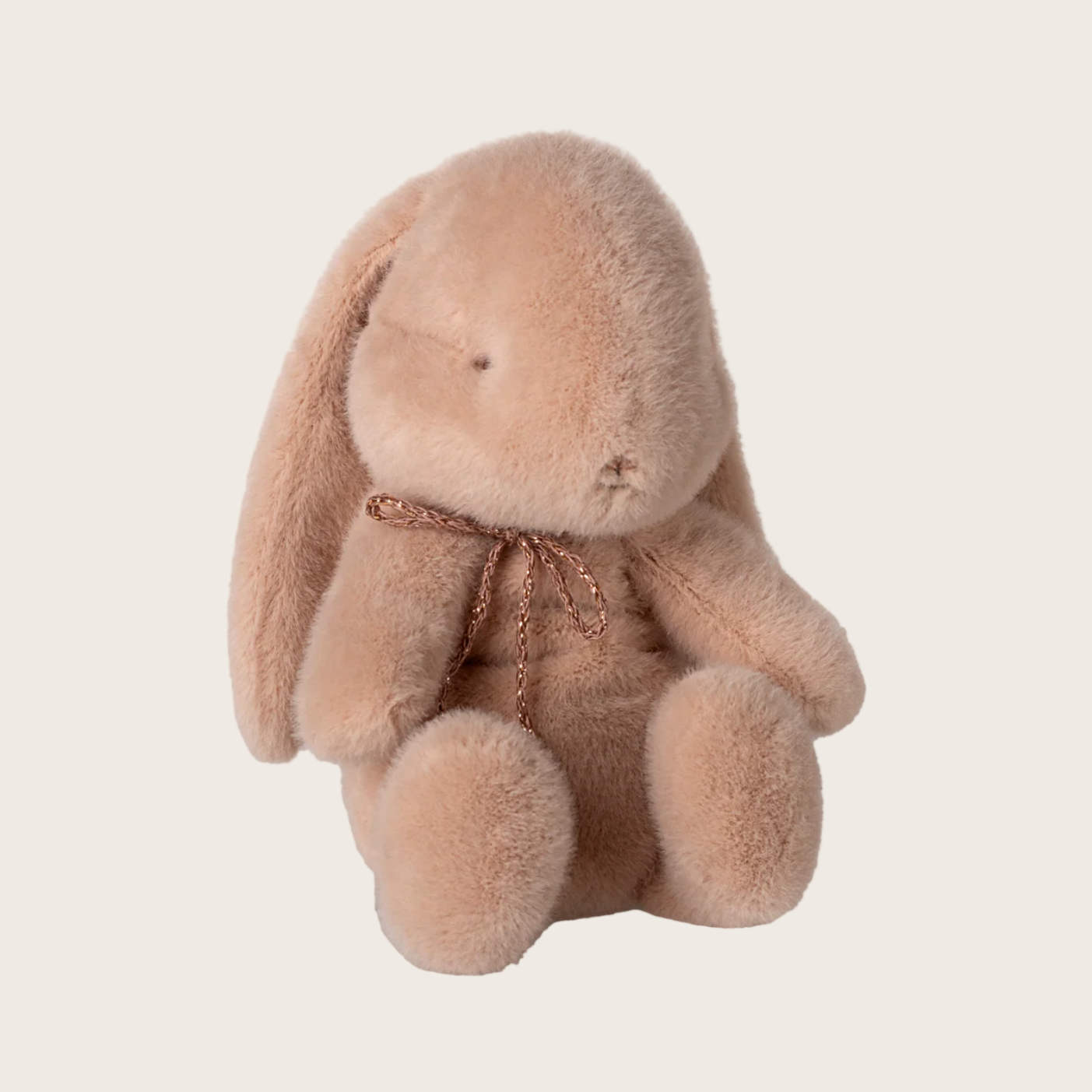 Plush bunny toy with a bow on a light gray background