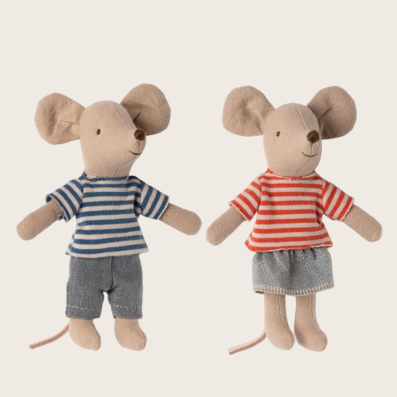 Two toy mice dressed in clothing 