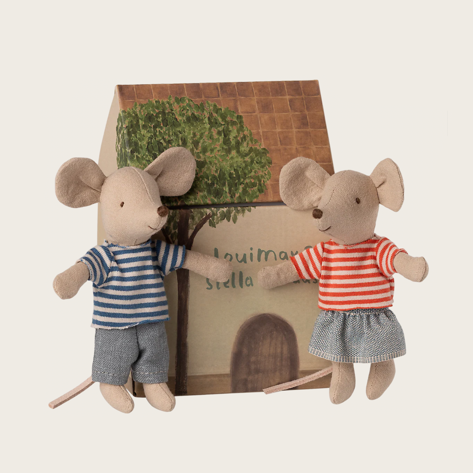 Two plush mouse toys in front of a small house with a tree 