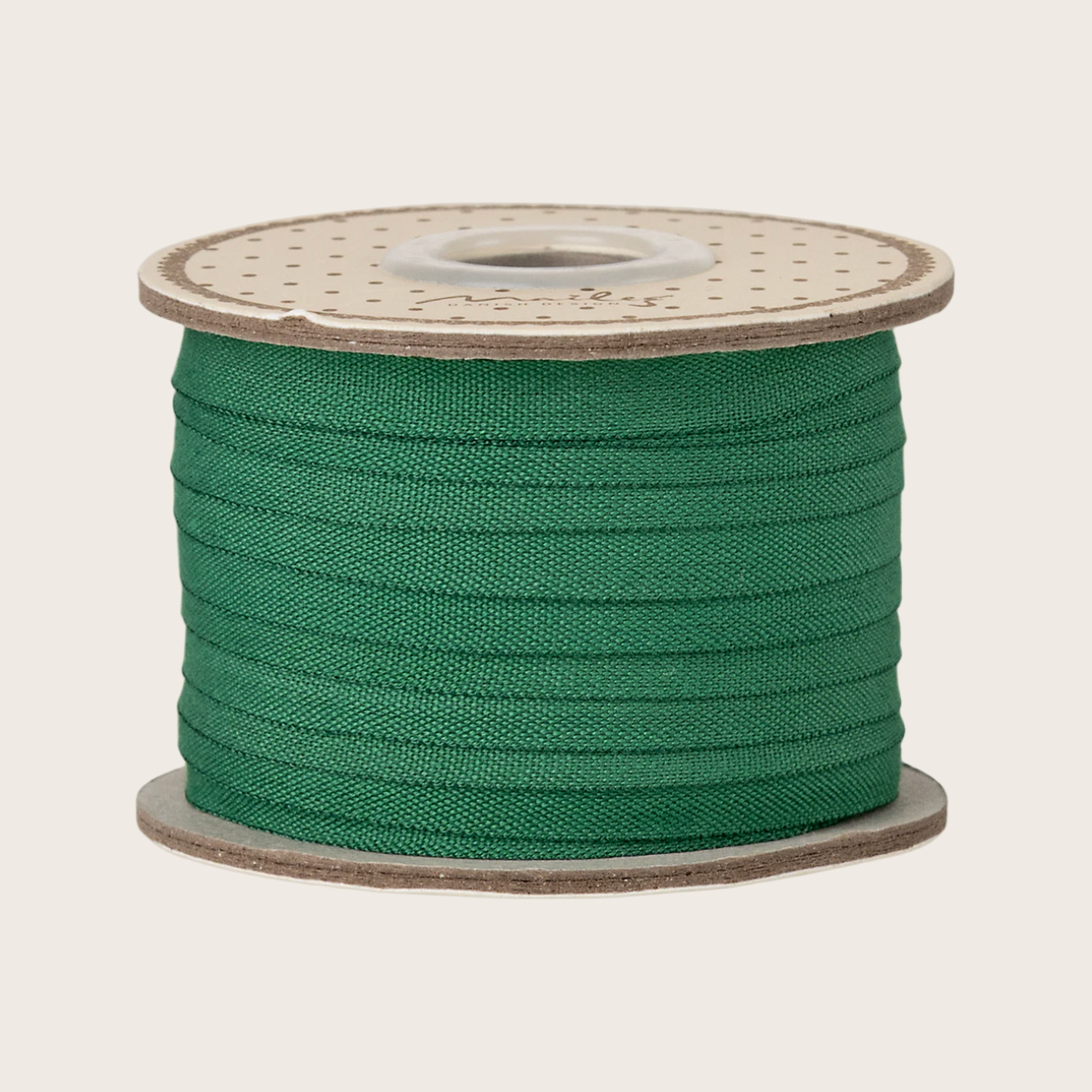Spool of green thread on a white background