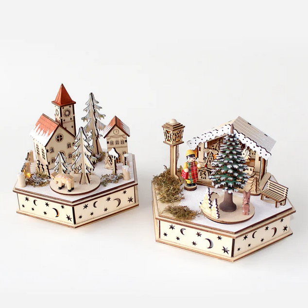 Two miniature wooden Christmas village sets on a white background