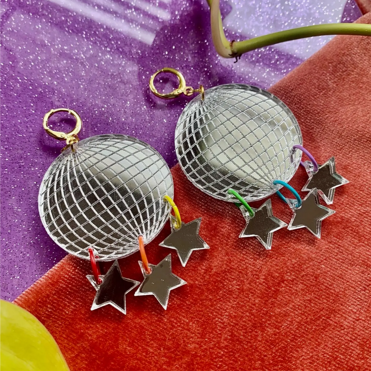 Decorative items with disco ball and star designs on a colorful background