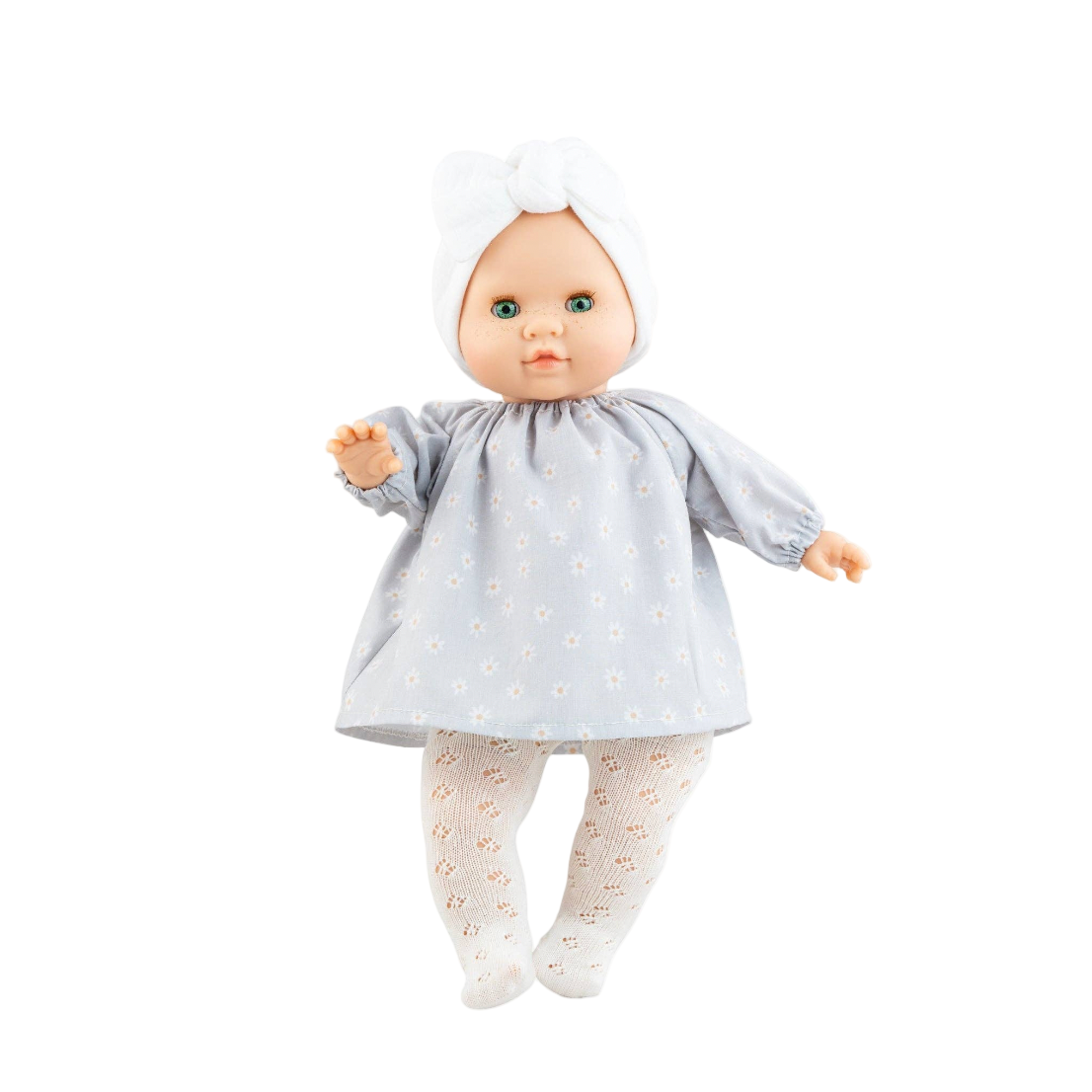 Doll wearing a gray dress with white polka dots on a white background