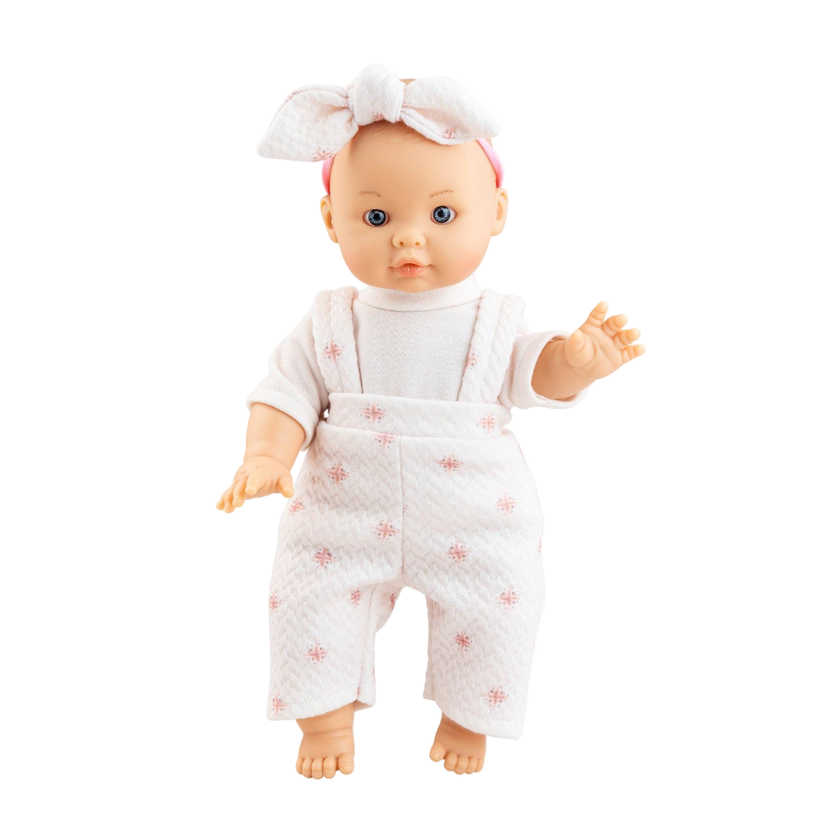 Baby doll wearing a white outfit with pink patterns on a white background