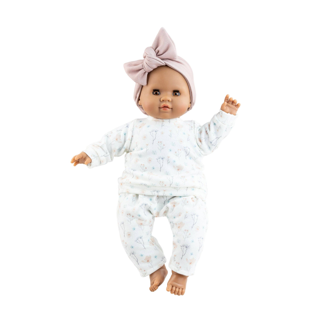 Baby doll wearing a white outfit with a pink bow on a white background