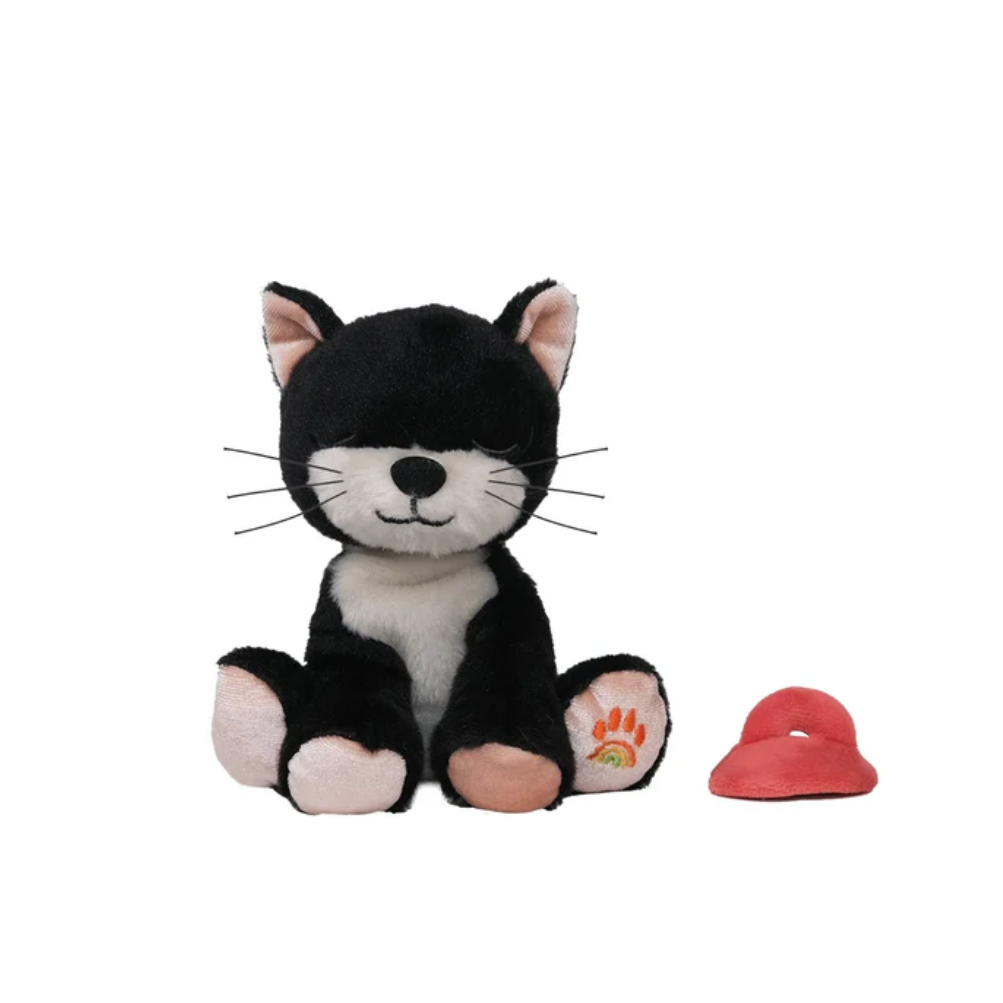 Black and white cat-shaped plush toy with a red item on a white background