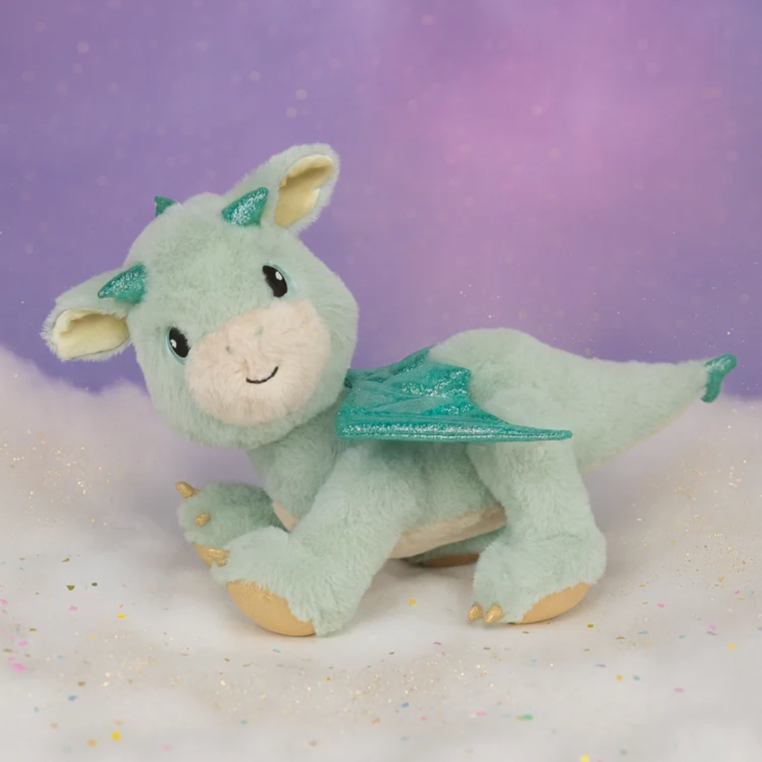 Plush dragon toy on a purple and white gradient background