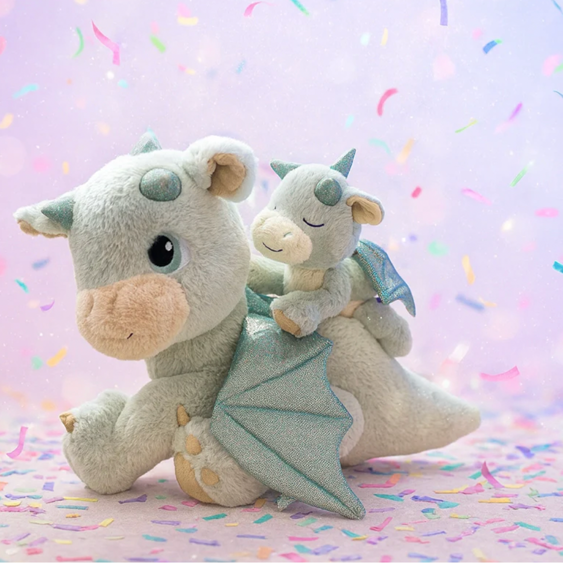 Two plush dragon toys on a colorful background with product details on the right.