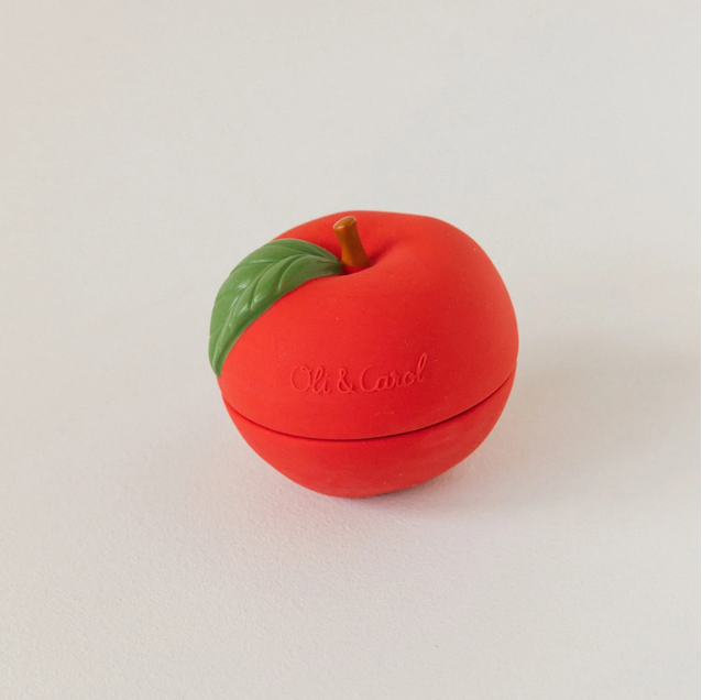 Red apple-shaped container with a green leaf on a light gray background
