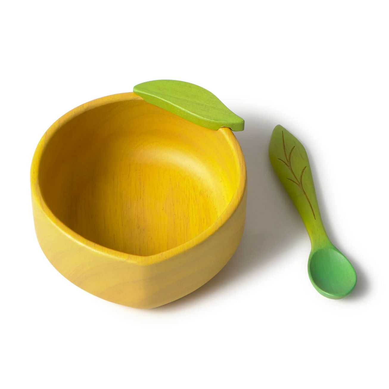 Yellow bowl with green leaf and matching spoon on a white background
