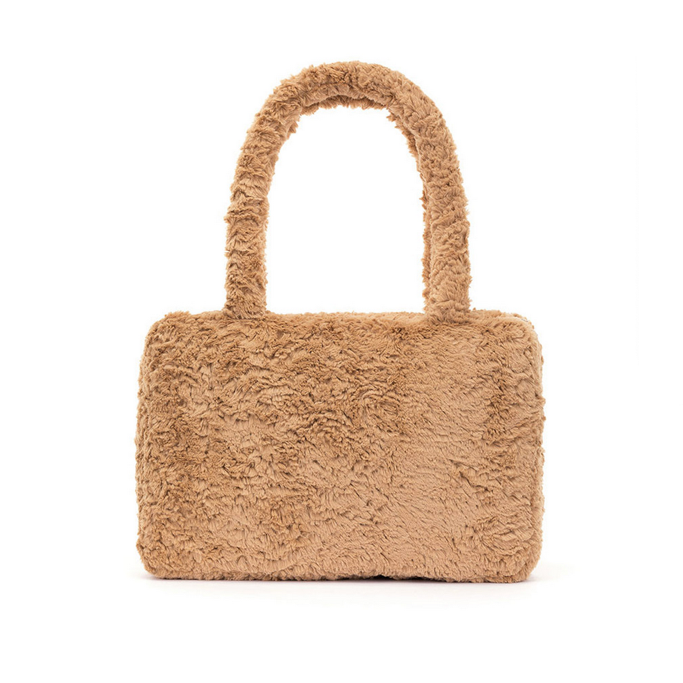 Beige fluffy tote bag with a woman in a red dress in the background