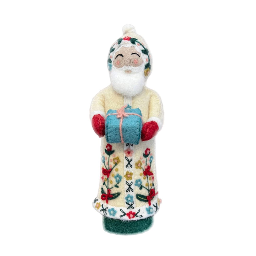 Decorative figure of a Santa Claus holding a gift box on a white background