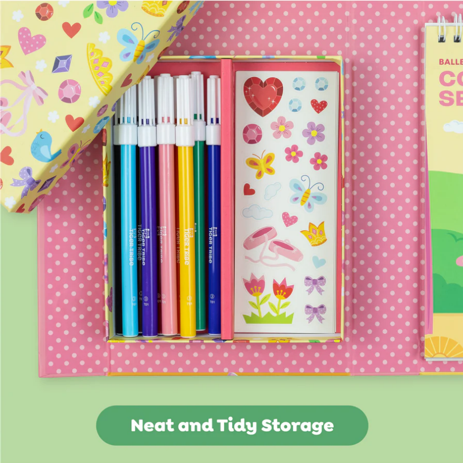 Colorful stationery set with pens and stickers in a pink polka dot box on a pink background.