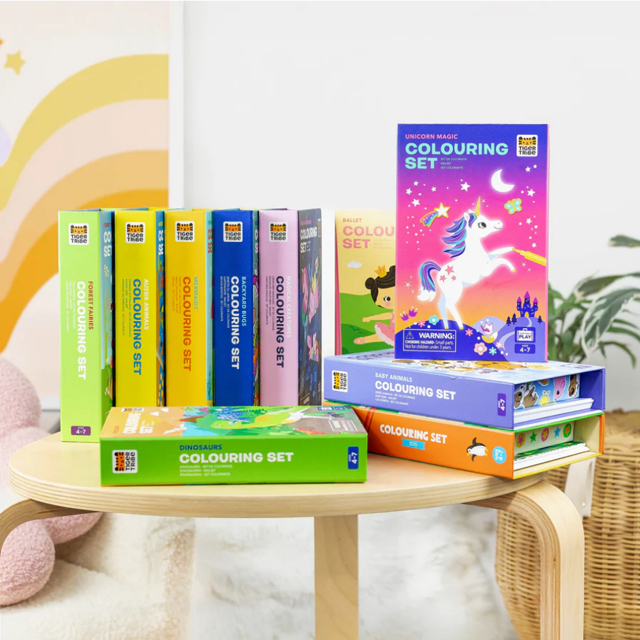 Collection of Colouring Sets on a wooden stool with a soft, blurred background