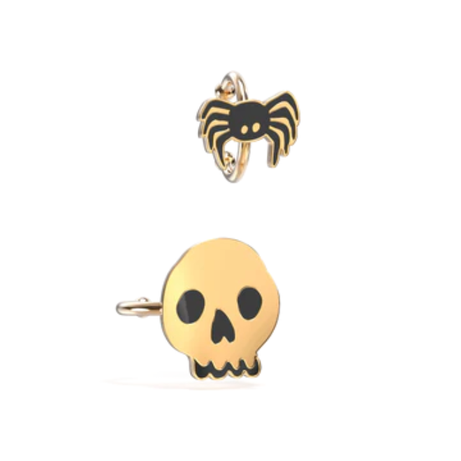 Gold skull and spider earrings on a white background