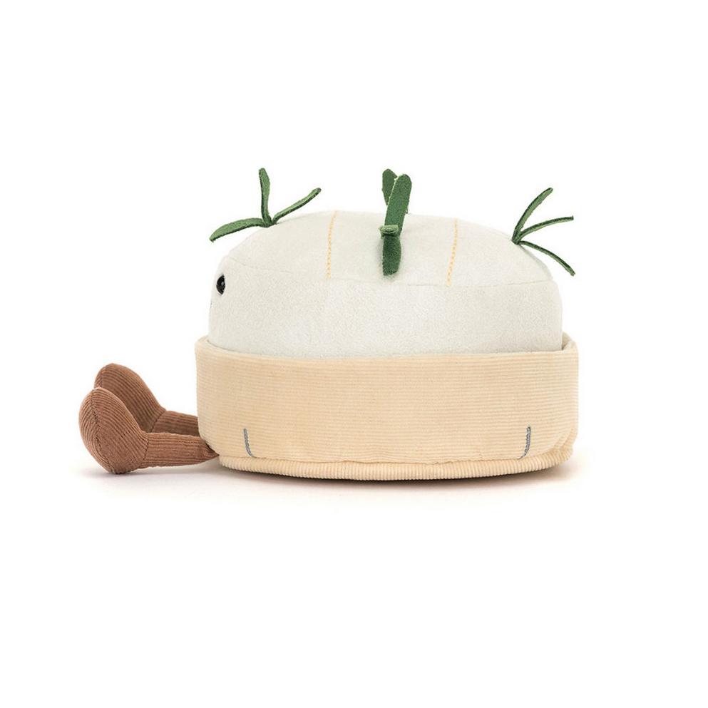 Stuffed toy shaped like a white cheese with green stems on a white background